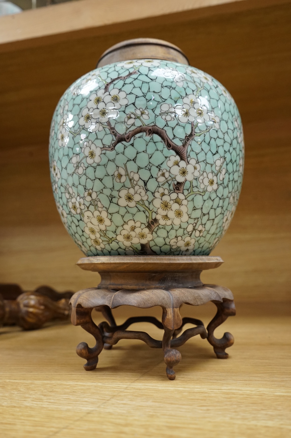 A Chinese famille verte enamelled prunus jar, 19th century, with wood cover and stand, 25cm high